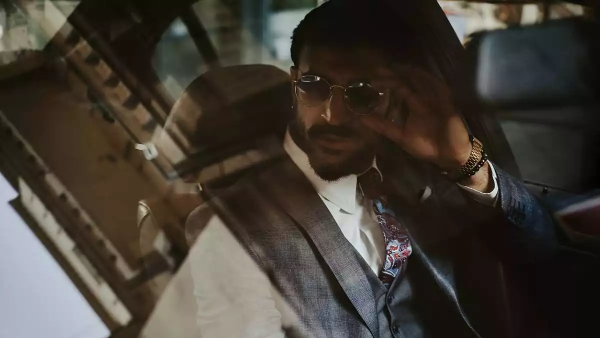 Man with sunglasses in a car.