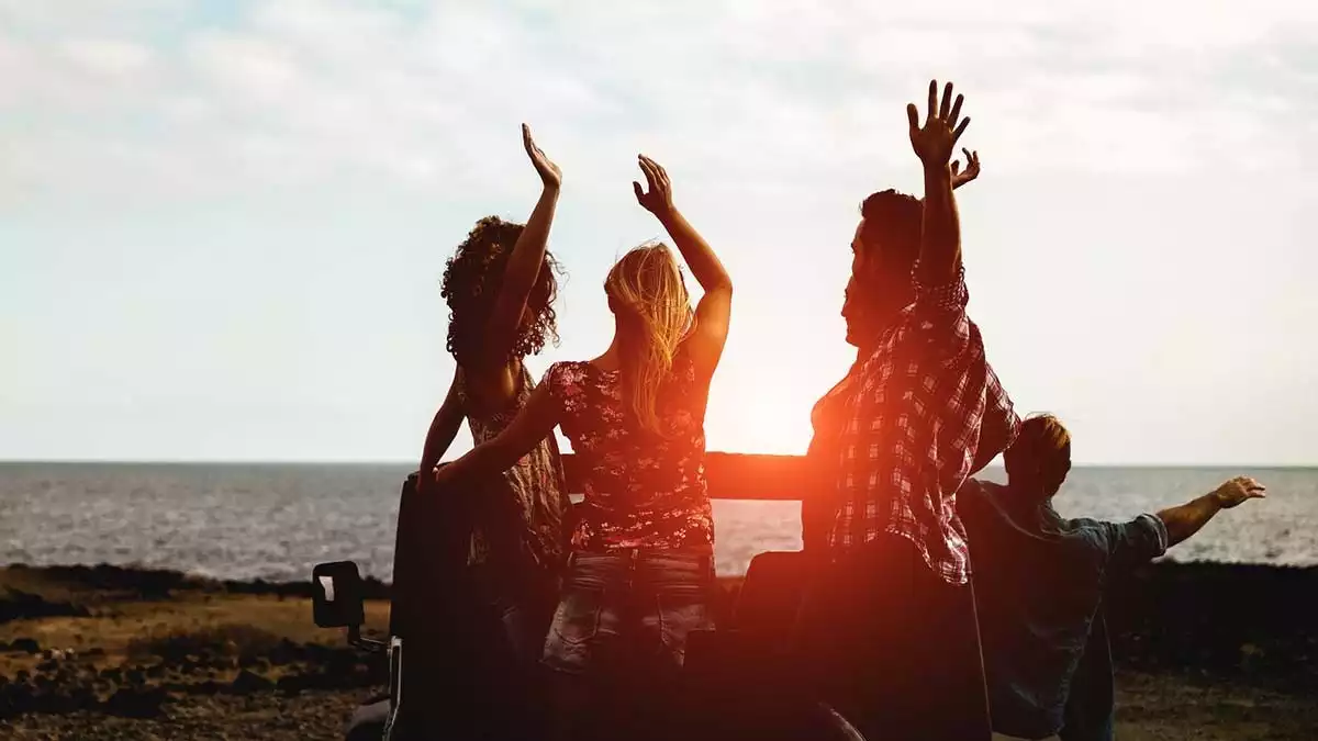 Group of Friends in front of the sea having fun.