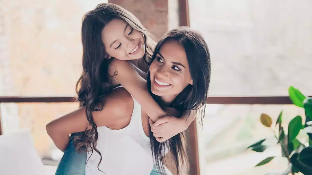 Mother with her daughter doing a piggy back