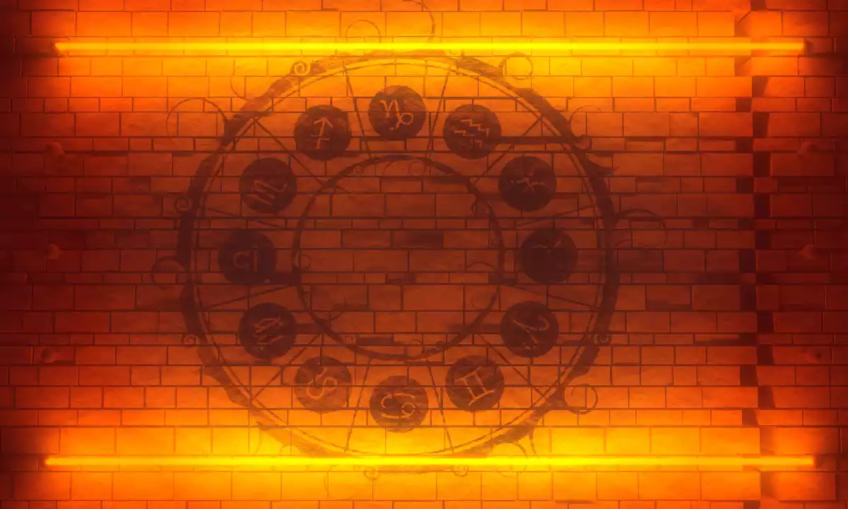Les 12 signes du zodiaque dans un cercle dessiné sur un mur en briques