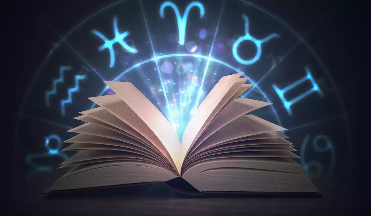 Un livre avec des éclairs bleus et en arrière-plan un cercle avec les 12 signes du zodiaque