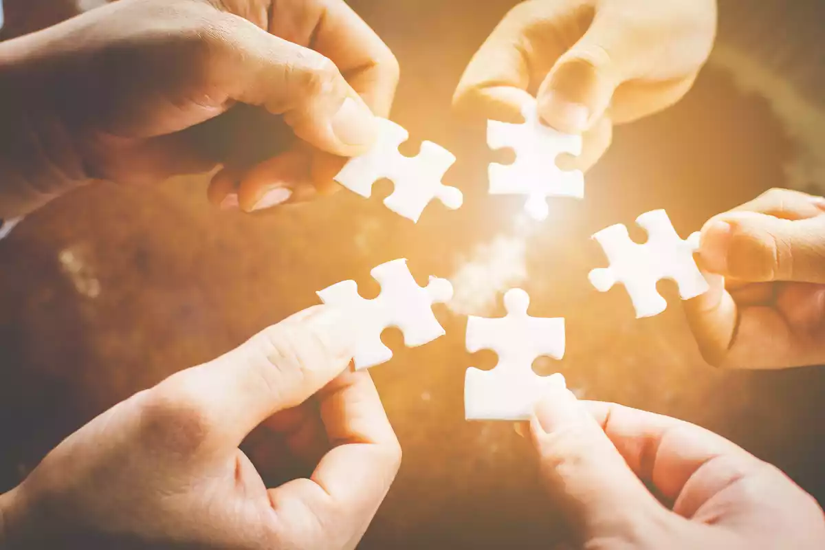 5 people holding a piece of jigsaw puzzle each