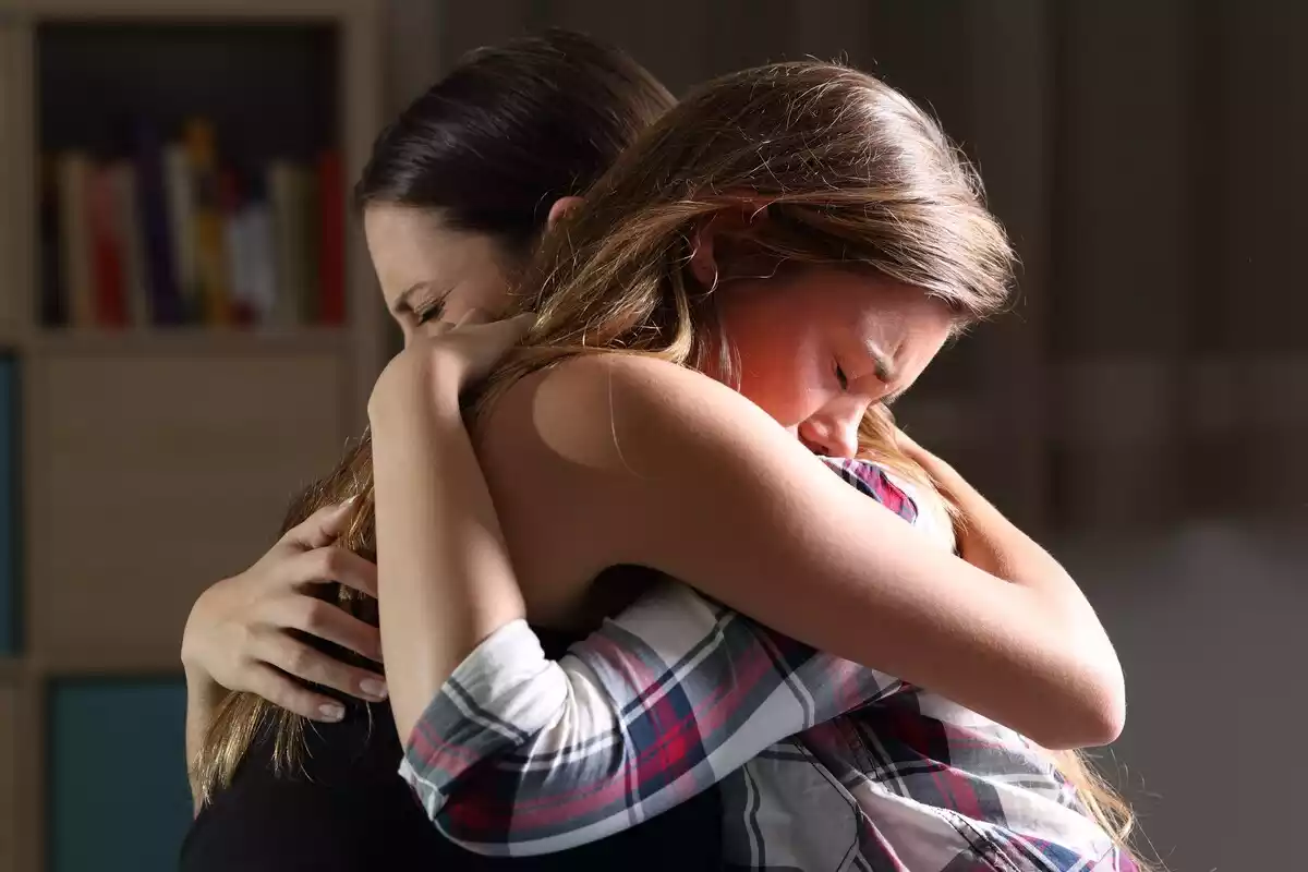 Two sad women hugging each other