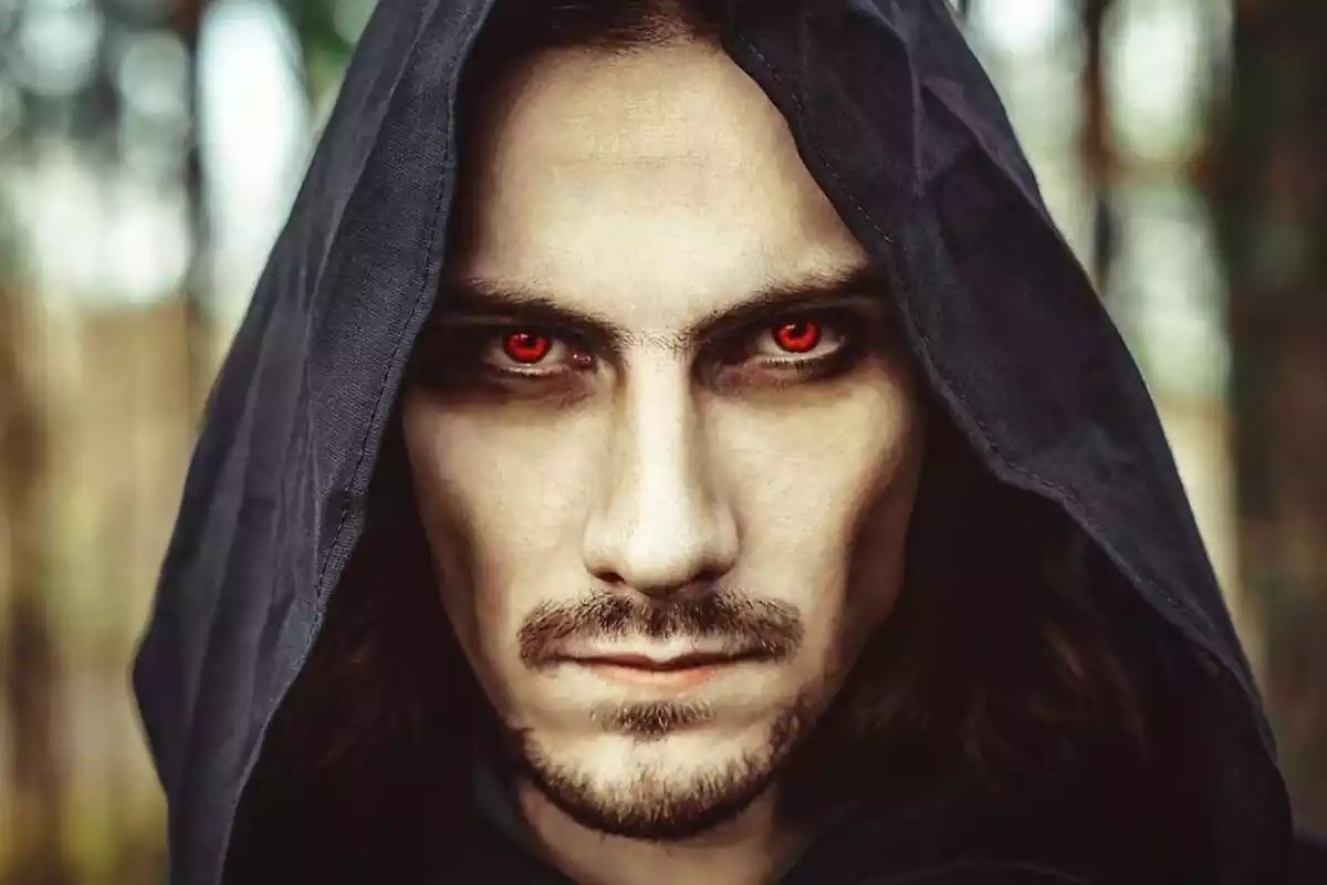 Image of a man with a hood and red eyes